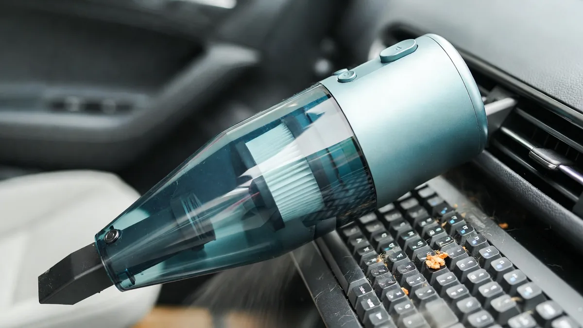 Rose-colored car cleaning gel putty applied to car crevices and keyboard surfaces.