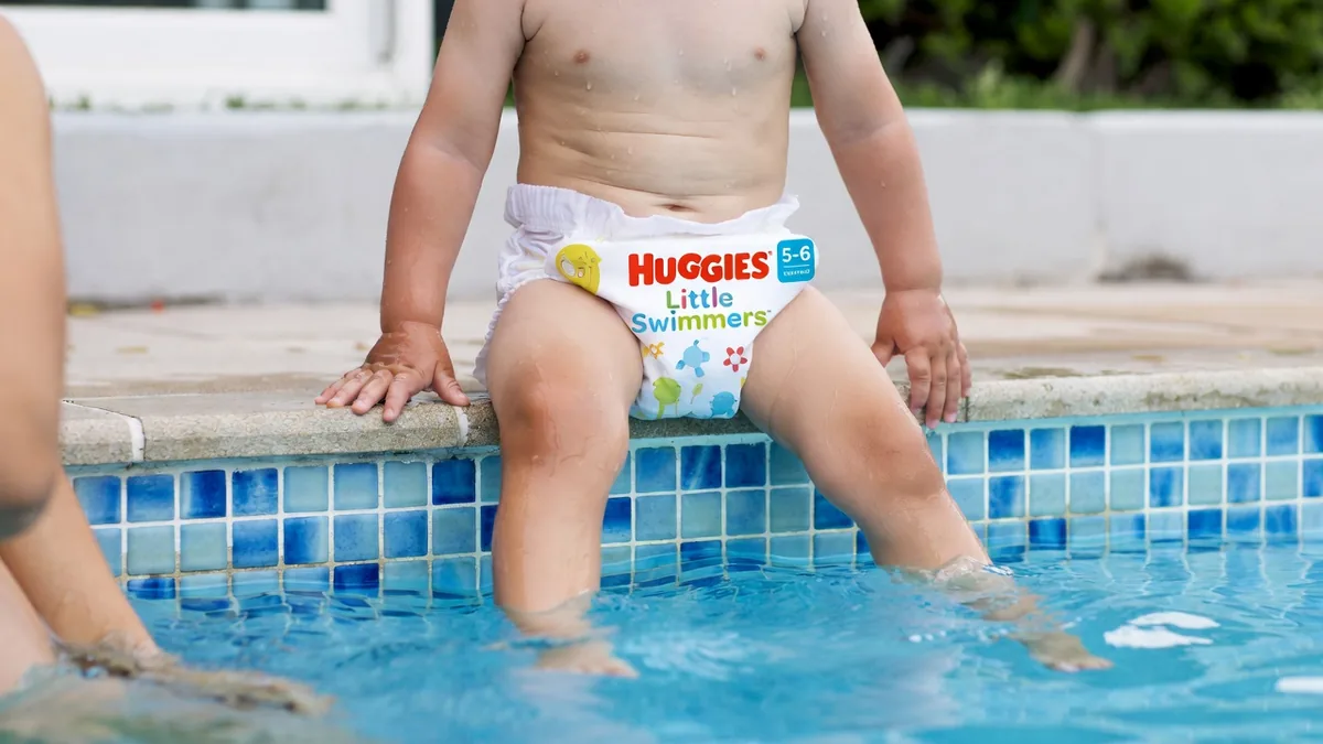 Huggies Little Swimmers disposable swim diapers for toddlers, size 5-6, shown with Disney Pixar Finding Nemo designs.