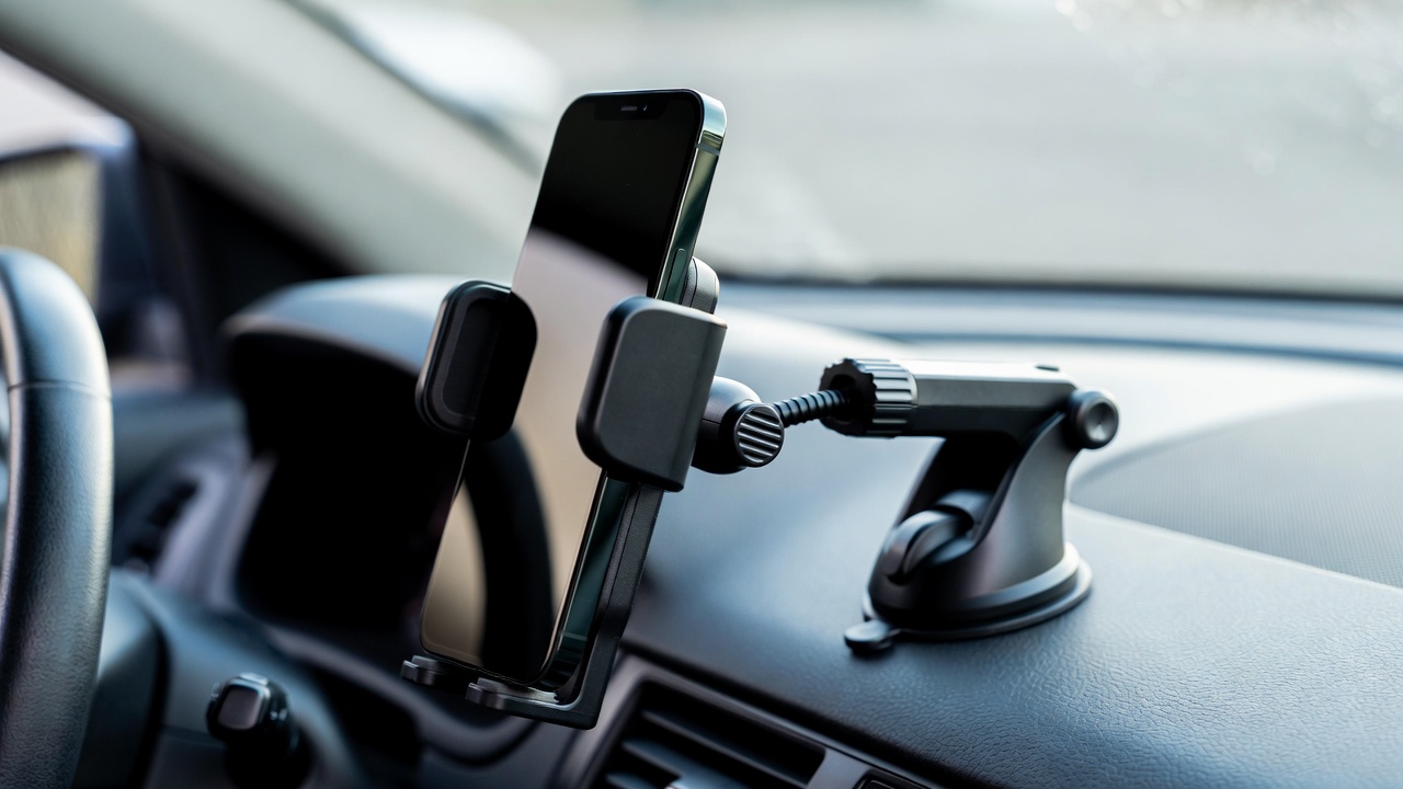 MagSafe car mount attached to a car dashboard with a smartphone in place