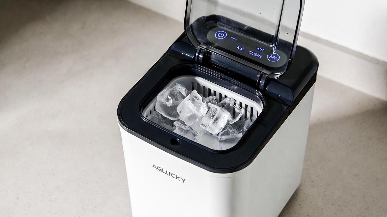 EUHOMY countertop nugget ice maker with stainless steel finish, ice basket, and scoop on a kitchen counter.